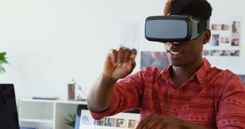 Young Man Using VR Headset in Office
