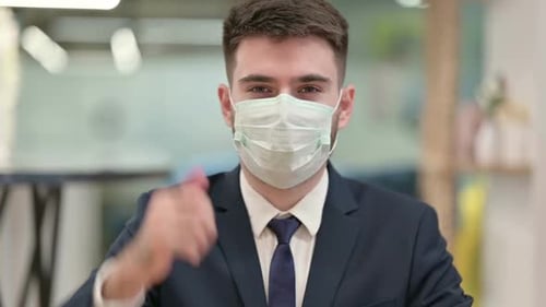 Businessman in Mask Gives Thumbs Up Approval