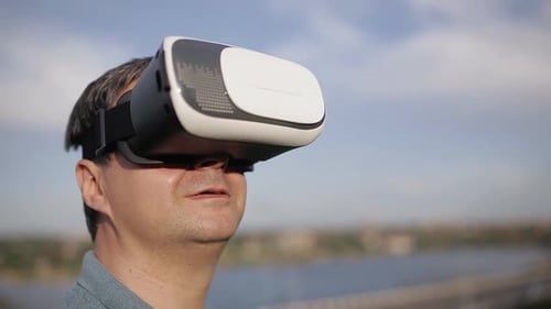 Man Uses Virtual Reality Goggles Outside