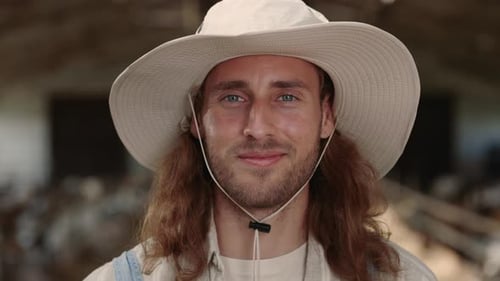 Smiling Caucasian Man in Hat Posing at Goat Farm