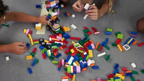 Children Playing with Building Blocks on Floor
