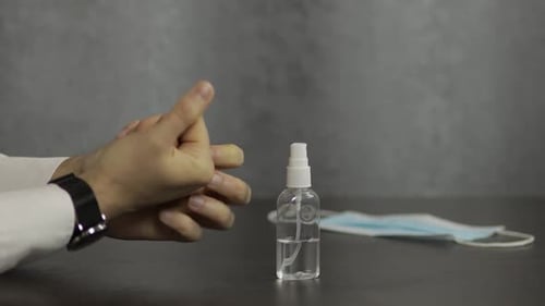 Man Applies Hand Sanitizer to Prevent Virus
