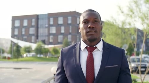 Confident Black Businessman Walking on Street