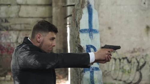 Man in Suit Shooting with Pistol in Abandoned Building