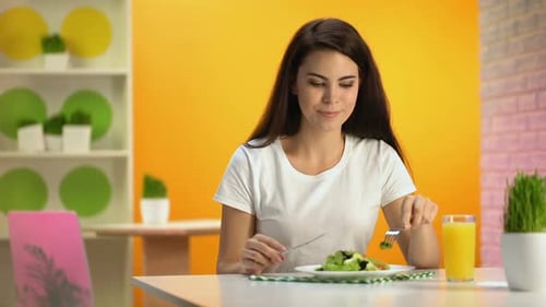 Female Vegetarian Eating Fresh Salad Sitting Cafe, Orange Juice Glass on Table
