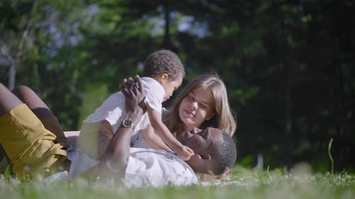 A Multicultural Family Lies in the Park