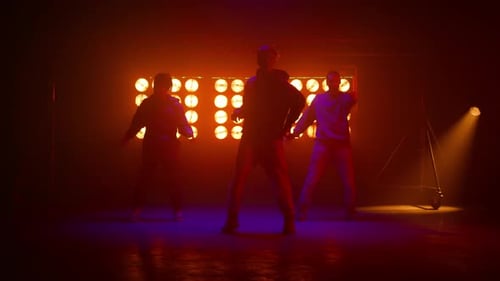 Energetic Dancers Performing Under Vibrant Stage Lights