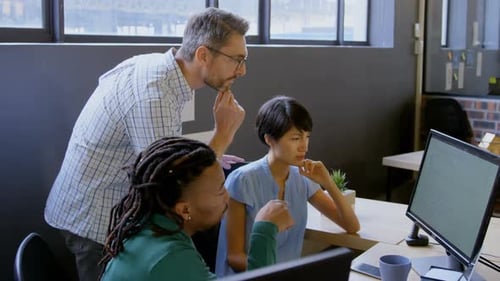 Business people discussing over computer in office 4k