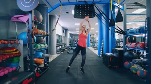 Full-length portrait of sportswoman in gym.