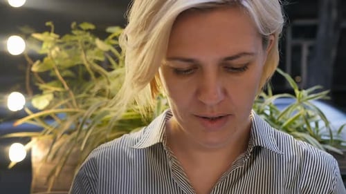 Woman with Short Blonde Hair at Night