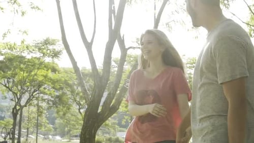 Young couple walking in park
