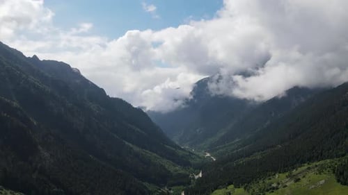 Aerial View of Lush Mountain Valley with Winding Road