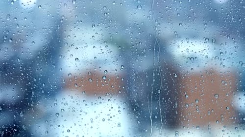 Raindrops Streaming Down a Window on a Cloudy Day