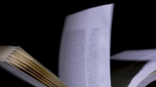 Open Book in the Studio on a Black Background