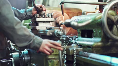 Metal Worker Operating a Lathe Machine
