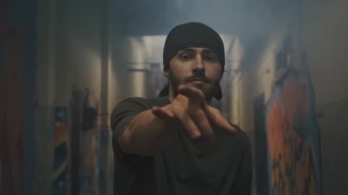 Young Man Dancing in Urban Graffiti Setting