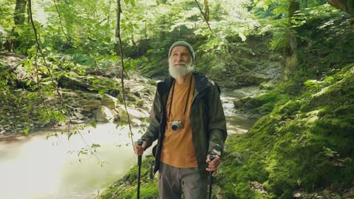 Happy Elderly Man with a Backpack and Nordic Walking Sticks Active Retirement
