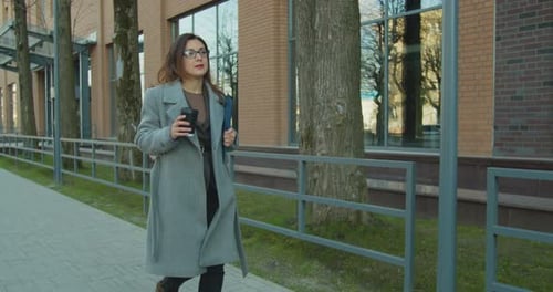 Business Woman Drinking Coffee to Go Walk Near Office Building