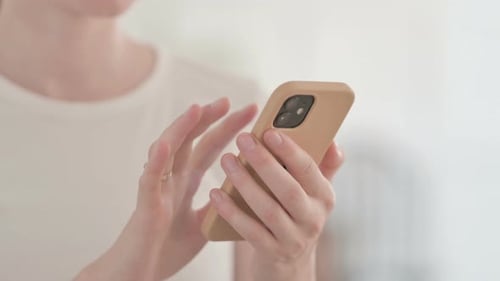 Close Up of Female Hand Using Smartphone Browsing Internet and Messaging