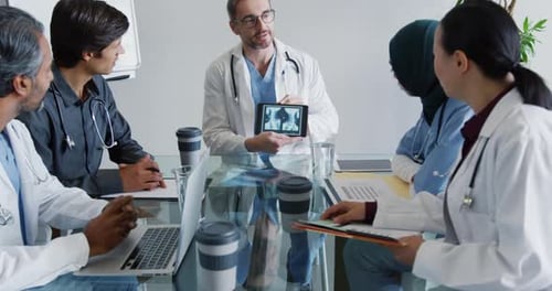 Medical Professionals Collaborating at Conference Table