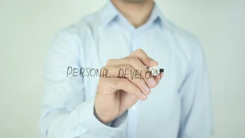 Man Writing Personal Development on Screen