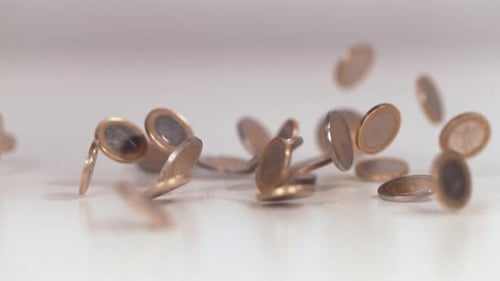 Euro Coins Falling Onto a White Surface