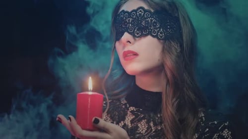 Woman with Lace Blindfold Holding Red Candle