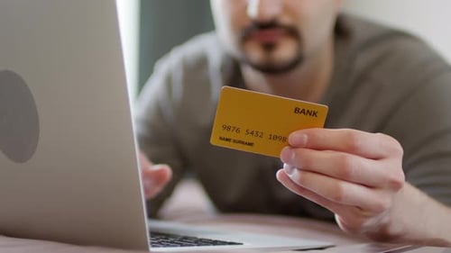 Young Adult Shopping Online with Bank Card