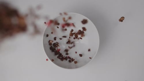 Muesli Pouring Into A Bowl