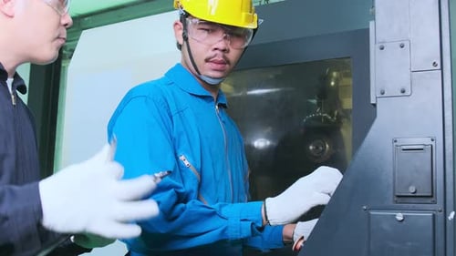 Professional engineering walking discuss inspecting with engineer team machinery factory area.