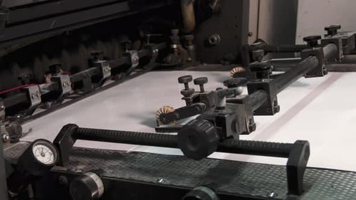 Sheet press moving sheets one by one in printing factory