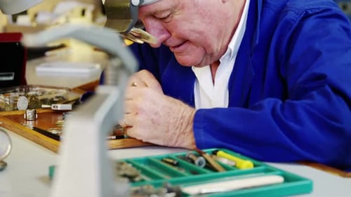 Horologist repairing a watch