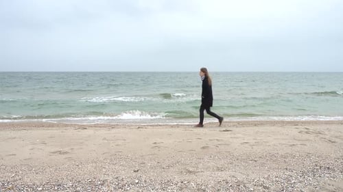 The Girl Walks on the Beach