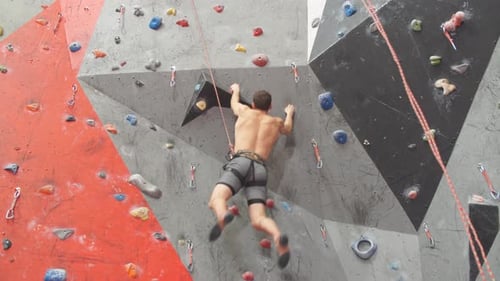 Man Climbing Indoor Rock Climbing Wall