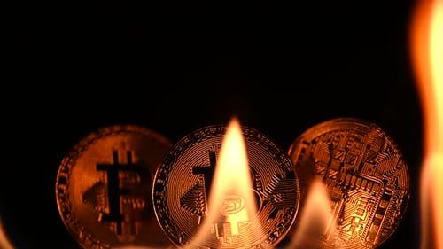Bitcoin Coins with Flames on Black Background