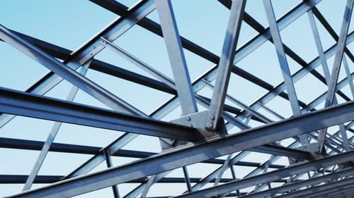 Seamless looping shot with camera moving along the unfinished steel roof