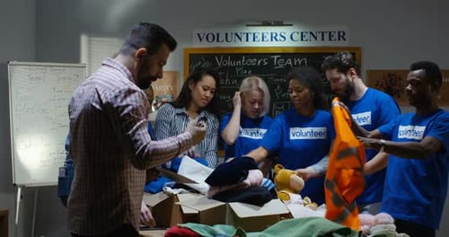 Volunteers Sorting Clothes and Toys for Charity