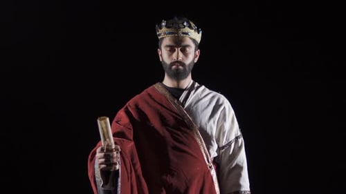 Man Wearing Crown and Robe Holds Scroll