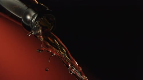 Alcohol Pouring Down From A Bottle Neck With Space For Text