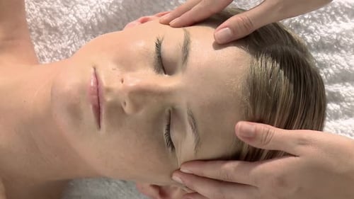 Woman Receives Relaxing Facial Massage at Spa