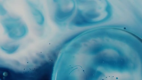 Macro Footage of Blue and White Paint Mixing