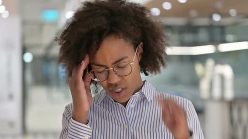 Young Woman with Headache Gestures to Stop