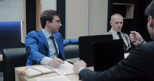 Businessmen Working Together at Office Meeting