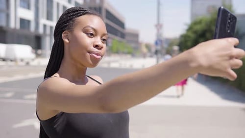 Woman Taking Selfie on Smartphone in City