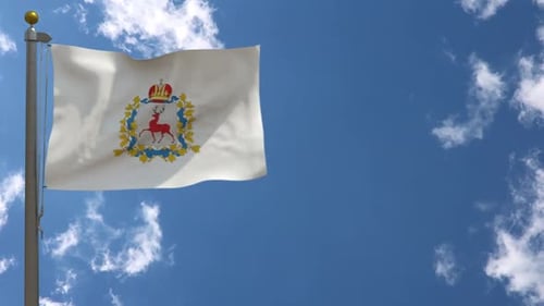 Waving Flag with Heraldic Coat of Arms Against Blue Sky