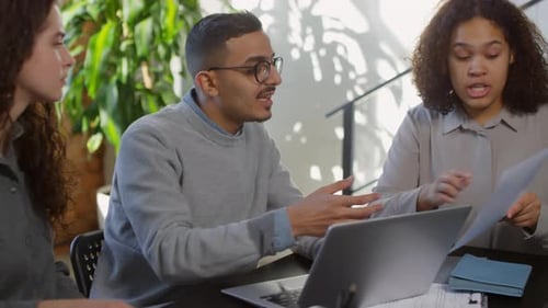 Three People Having a Business Meeting at Work