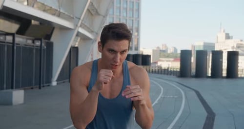 Muscular Man Shadow Boxing in Urban Environment
