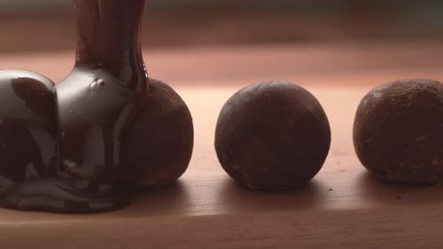 Schokolade gießt in Superzeitlupe auf Trüffel. Aufgenommen mit Phantom Flex 4K Hochgeschwindigkeitsk