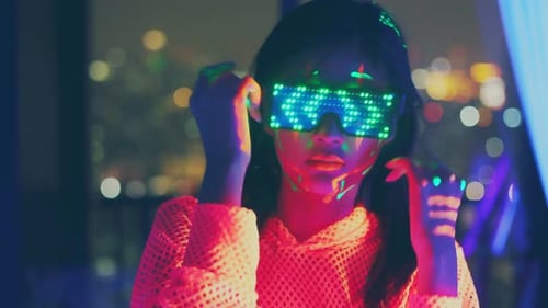 Neon asian woman dancing. Fashion model woman in neon light,