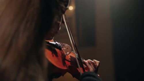 Woman Violinist in Black Clothes is Playing Classic Music in Dark Philharmonic Hall